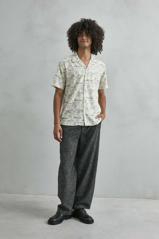 Detalle estampado tropical mar y palmeras camisa hawaiana