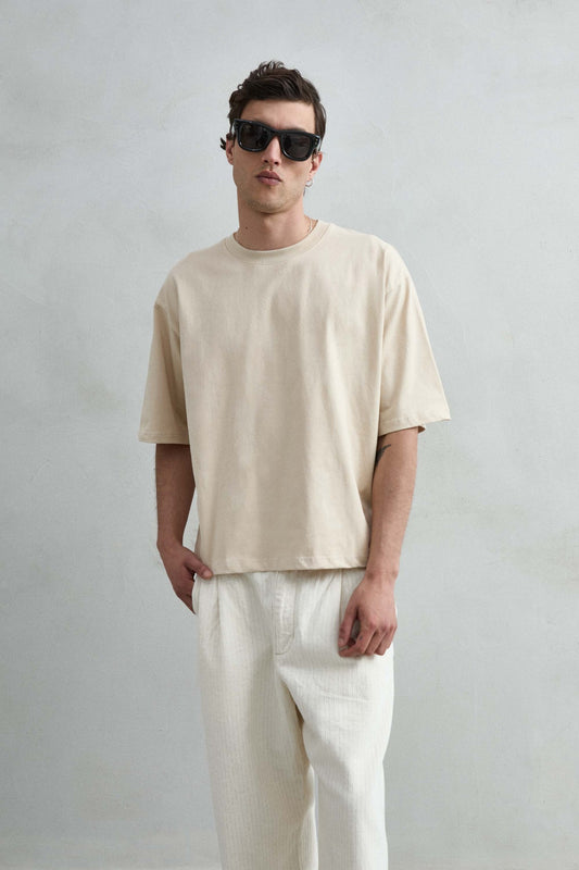 Camiseta cropped oversize beige lisa de hombre, vista frontal.