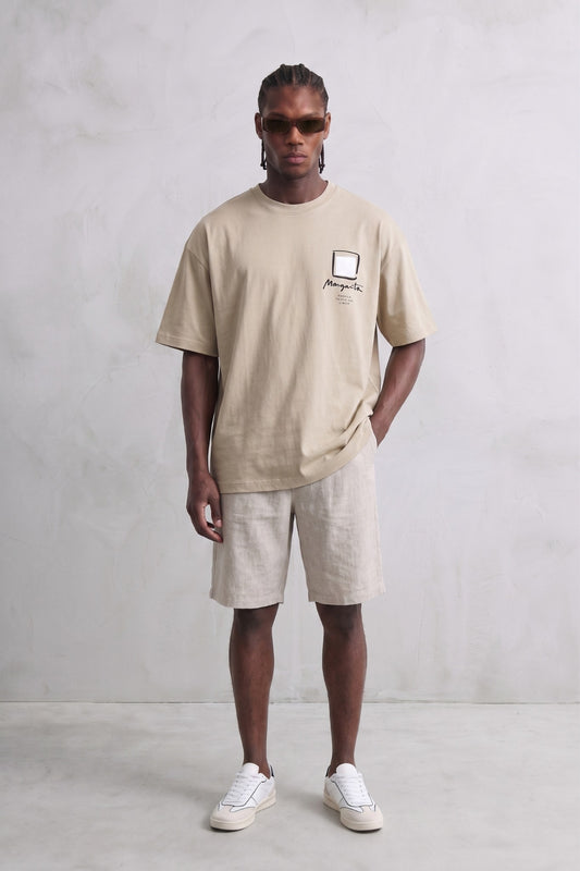 Camiseta oversize beige con estampado geométrico, vista de cuerpo entero.