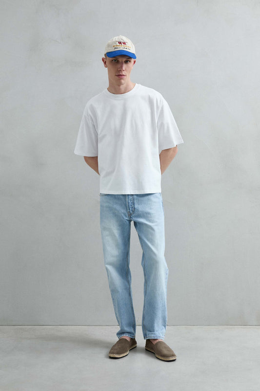 Camiseta oversize blanca lisa, vista frontal de cuerpo entero.