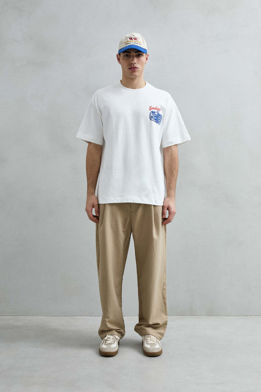 Vista frontal de cuerpo entero de la camiseta oversize blanca Sardines, con hombros caídos, manga corta amplia y bajo recto.