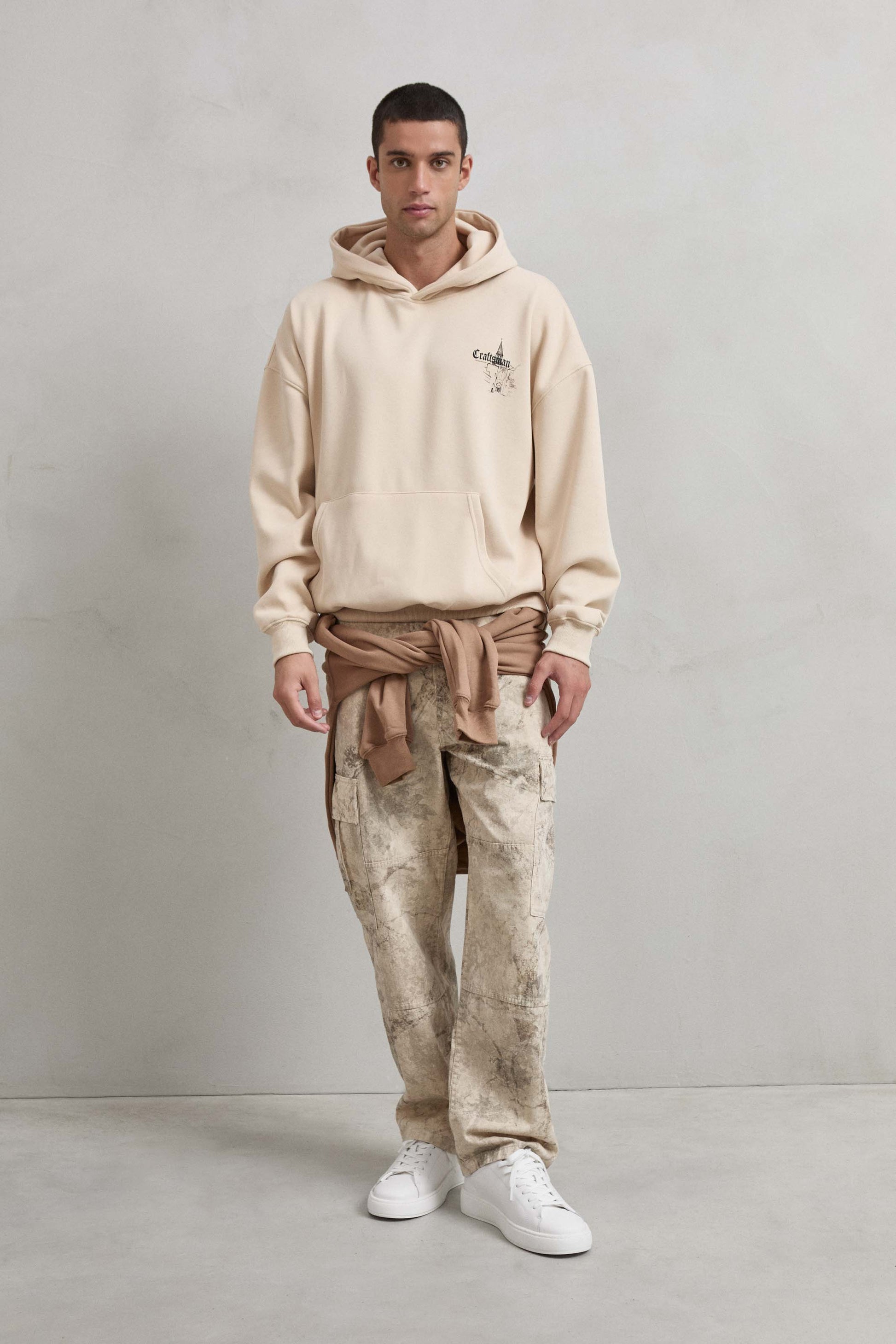 Look completo con sudadera beige CRAFTSMAN y castillo europeo