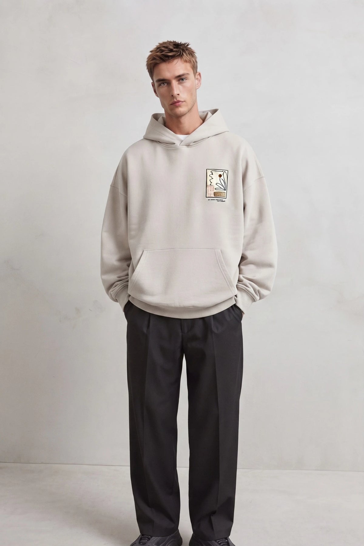 Vista frontal de cuerpo entero con sudadera beige de diseño botánico y pantalones negros