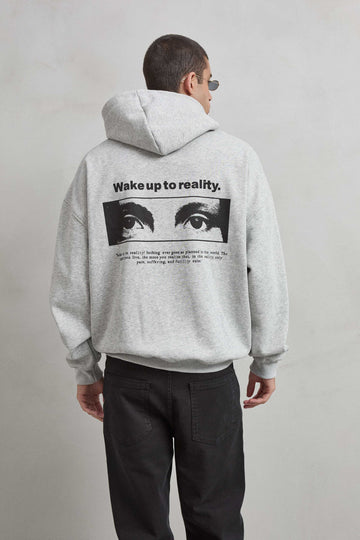 Sudadera gris jaspe con gráfico de ojos y texto “WAKE UP TO REALITY”