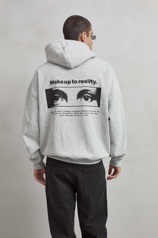 Sudadera gris jaspe con gráfico de ojos y texto “WAKE UP TO REALITY”