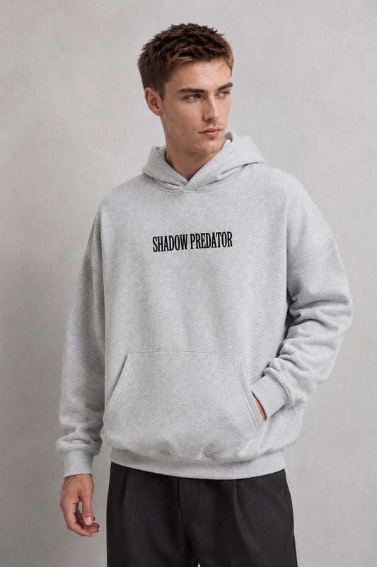 Sudadera gris jaspe oversize de hombre con capucha y texto Shadow Predator, vista frontal