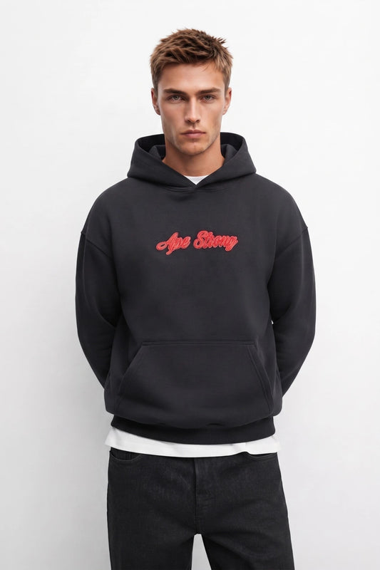 Sudadera negra oversize de hombre con capucha y letras rojas Ape Strong, vista frontal
